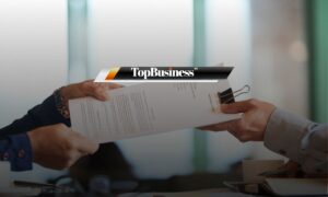 Photo of a boss handing over a probation letter or contract to an employee, during a probation period in Malaysia.